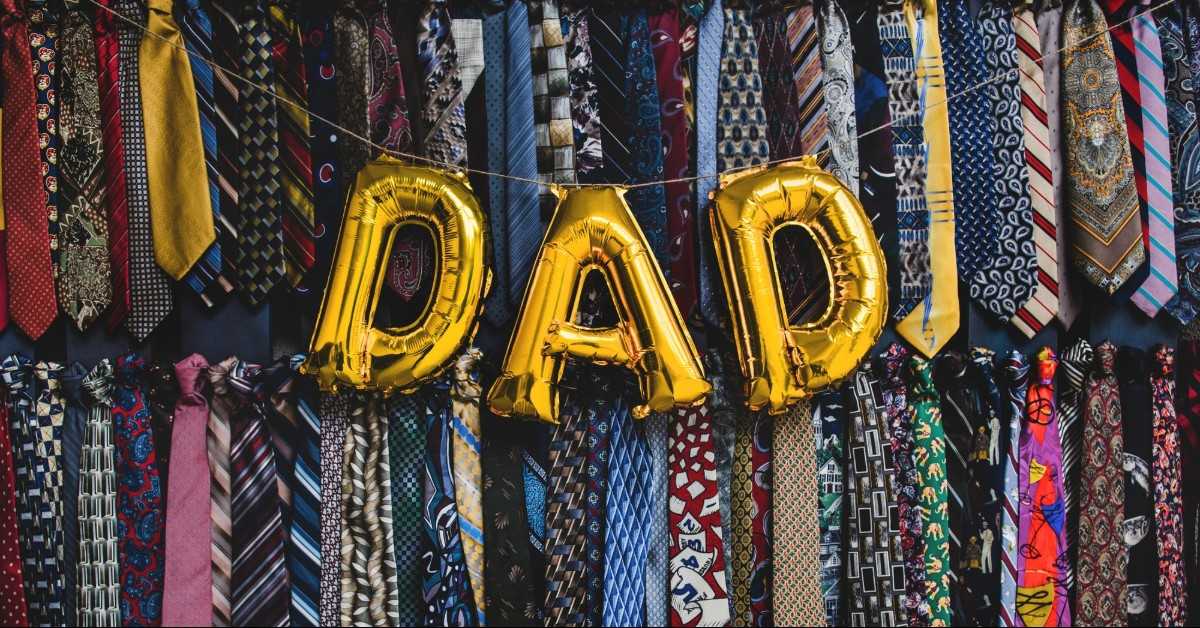 Father's Day special gold balloons that spell out "DAD" with a background of various ties