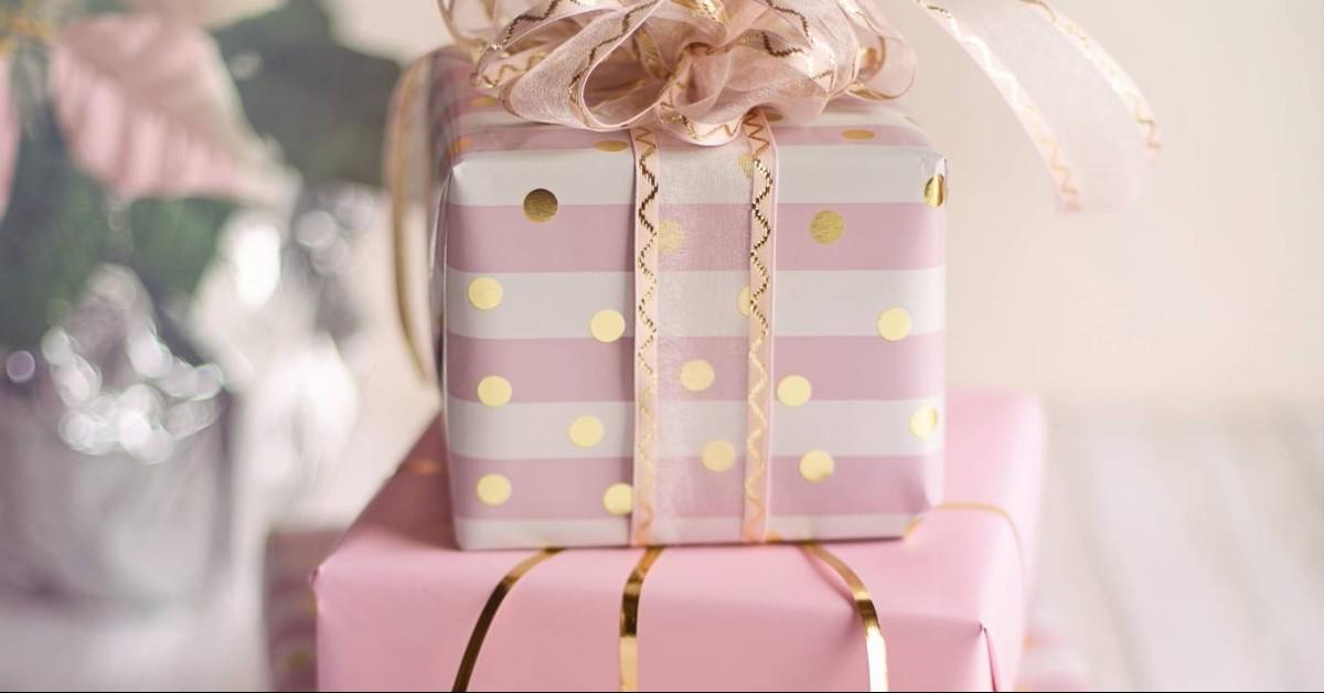 bridal shower gifts wrapped in pink, white, and gold