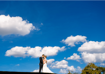 Bride and groom together at the top of the hill