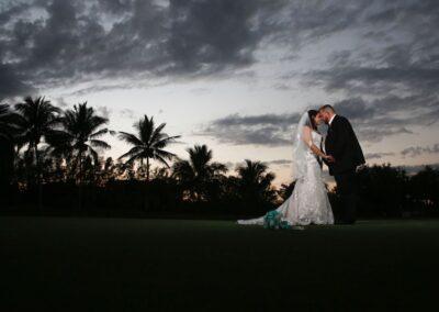 a bride and groom at night on our south Florida golf course